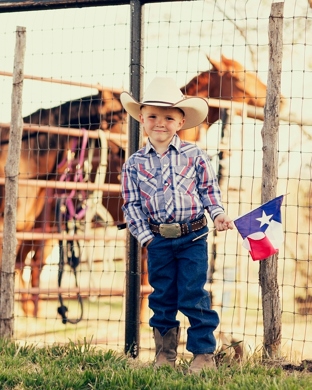 HCSC- A young cowboy shall proud to display the flag of Texas.